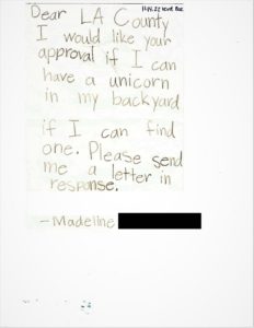 A handwritten letter from a child addressed to Los Angeles County, requesting permission to keep a unicorn in her backyard.